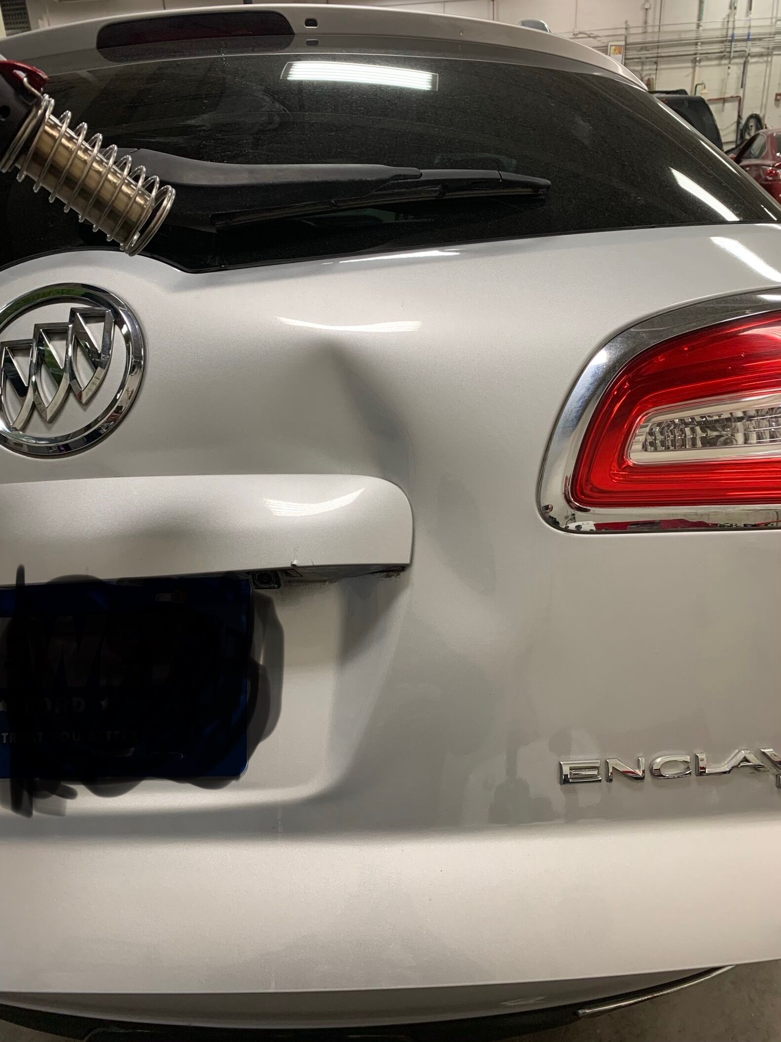 buick enclave with a large dent on the trunk
