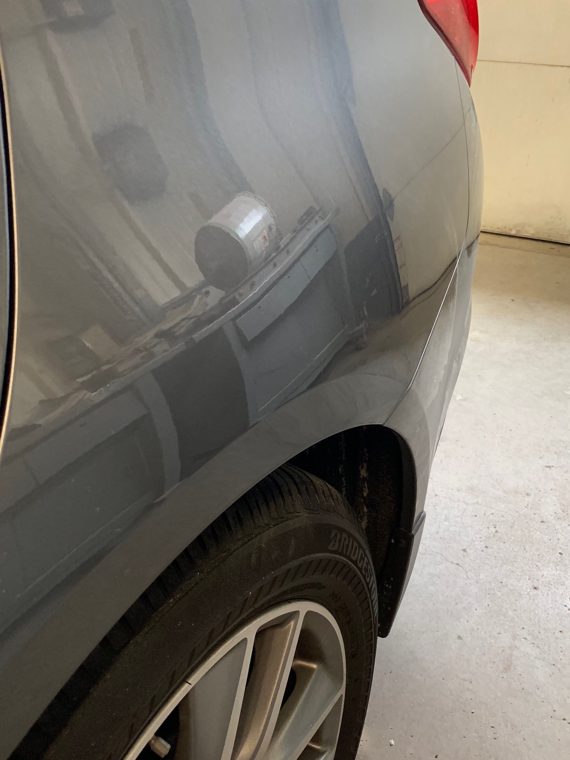 a gray car with the large dent completely fixed