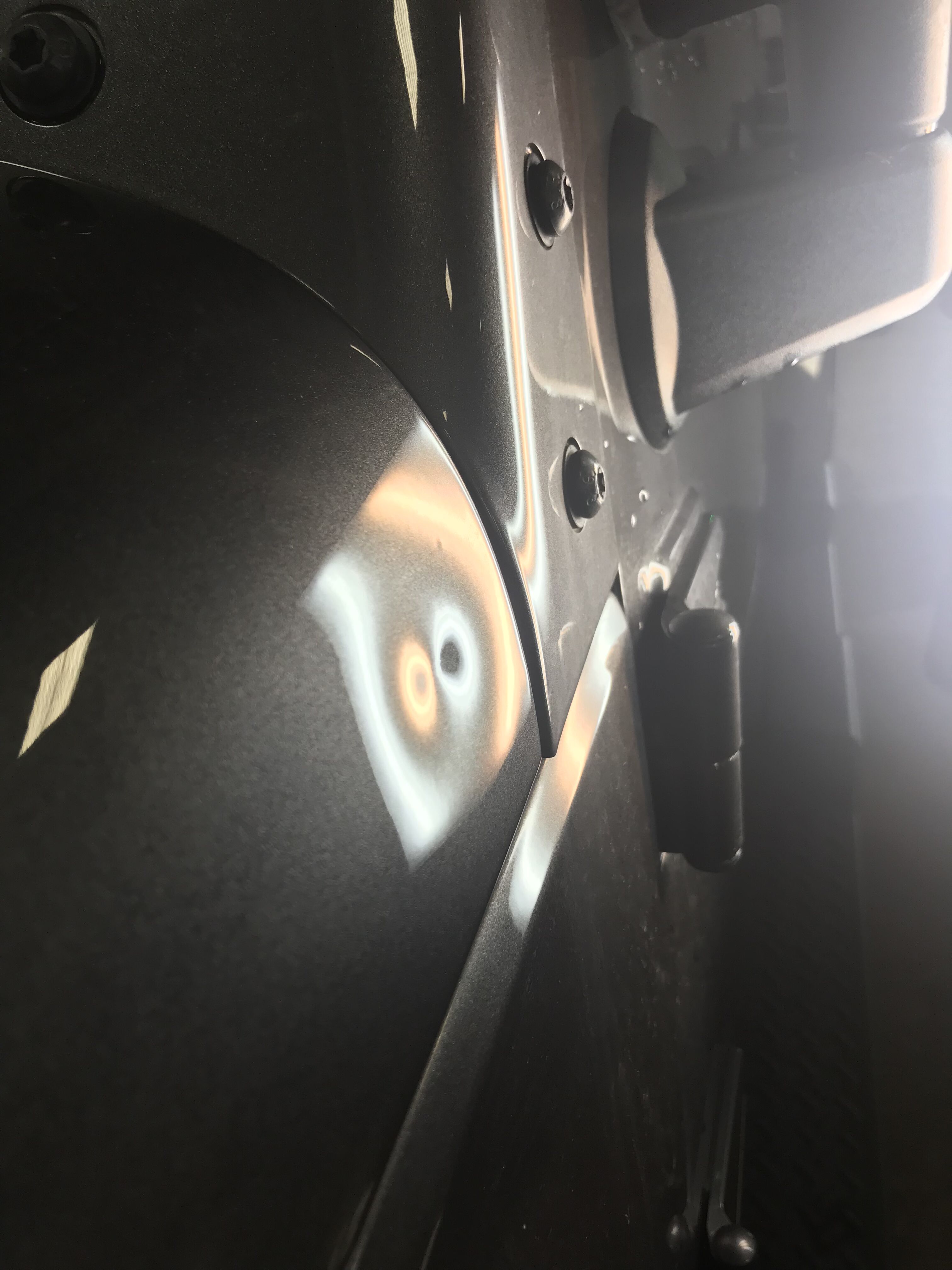 a jeep with a small dent on the side of it's hood