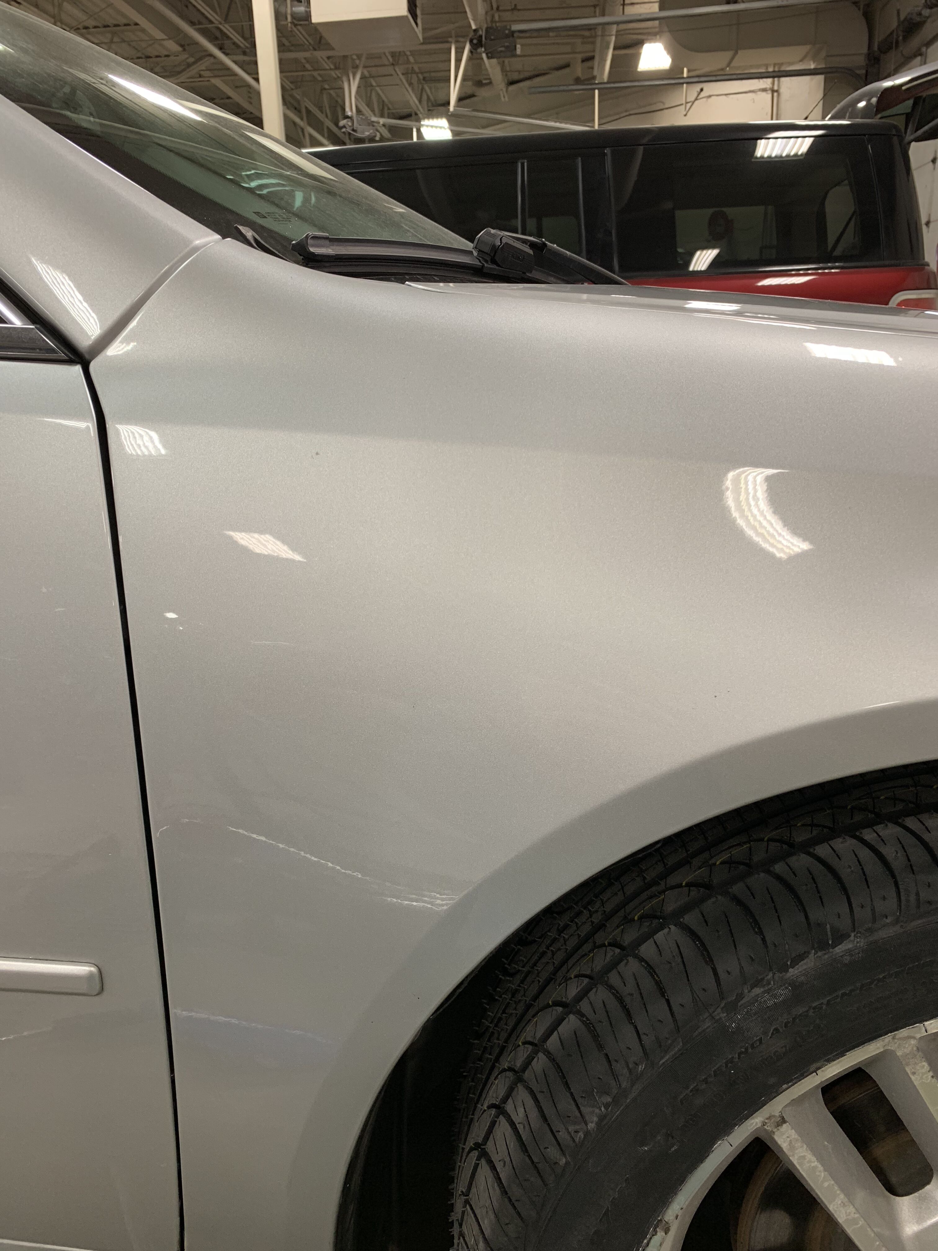 the silver car with it's dent fixed