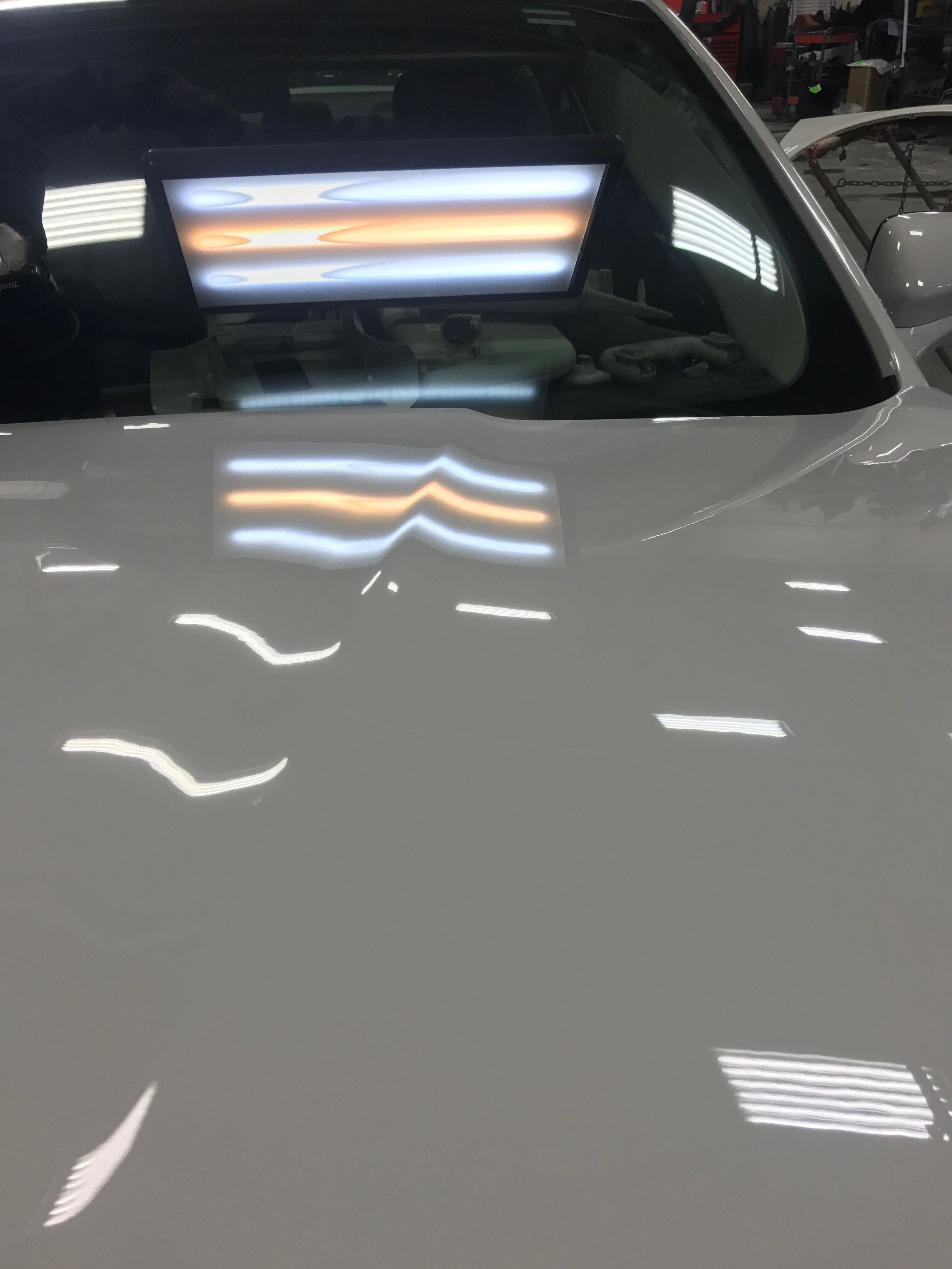 the white car with the small dents fixed